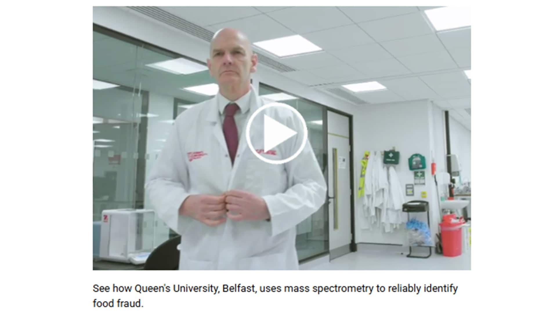 Scientist in a lab coat stands confidently in a modern laboratory, illustrating the use of mass spectrometry at Queen&rsquo;s University Belfast to combat food fraud.