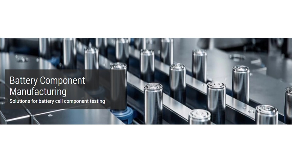 Battery manufacturing setting with rows of cylindrical battery cells in a sleek, modern factory. Text overlay reads 'Battery Component Manufacturing: Solutions for battery cell component testing.' The scene conveys precision and high-tech innovation.